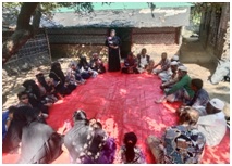 A Community Facilitator is conducting a session on DRR